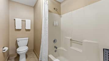 A bathroom with a toilet, shower, and bathtub.
