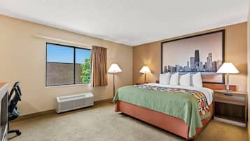 A hotel room with a bed, two bedside lamps, a window with curtains, a radiator, and a cityscape painting on the wall.