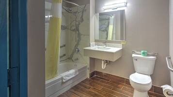 A bathroom with a shower, bathtub, sink, and toilet.