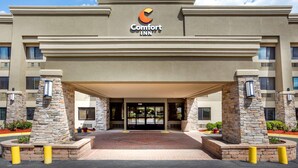 A Comfort Inn hotel entrance with a stone facade, a central entrance, and a clear sky. - Comfort Inn Hoffman Estates - Schaumburg (Hoffman Estates)