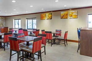 Enjoy casual dining in this stylish space with a reception desk and framed artwork.