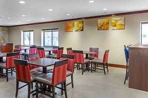 Enjoy casual dining in this stylish space with a reception desk and framed artwork.