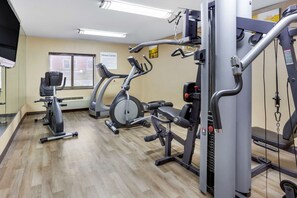 Stay active in our fully equipped fitness center featuring a treadmill, stationary bike, and weight machine.