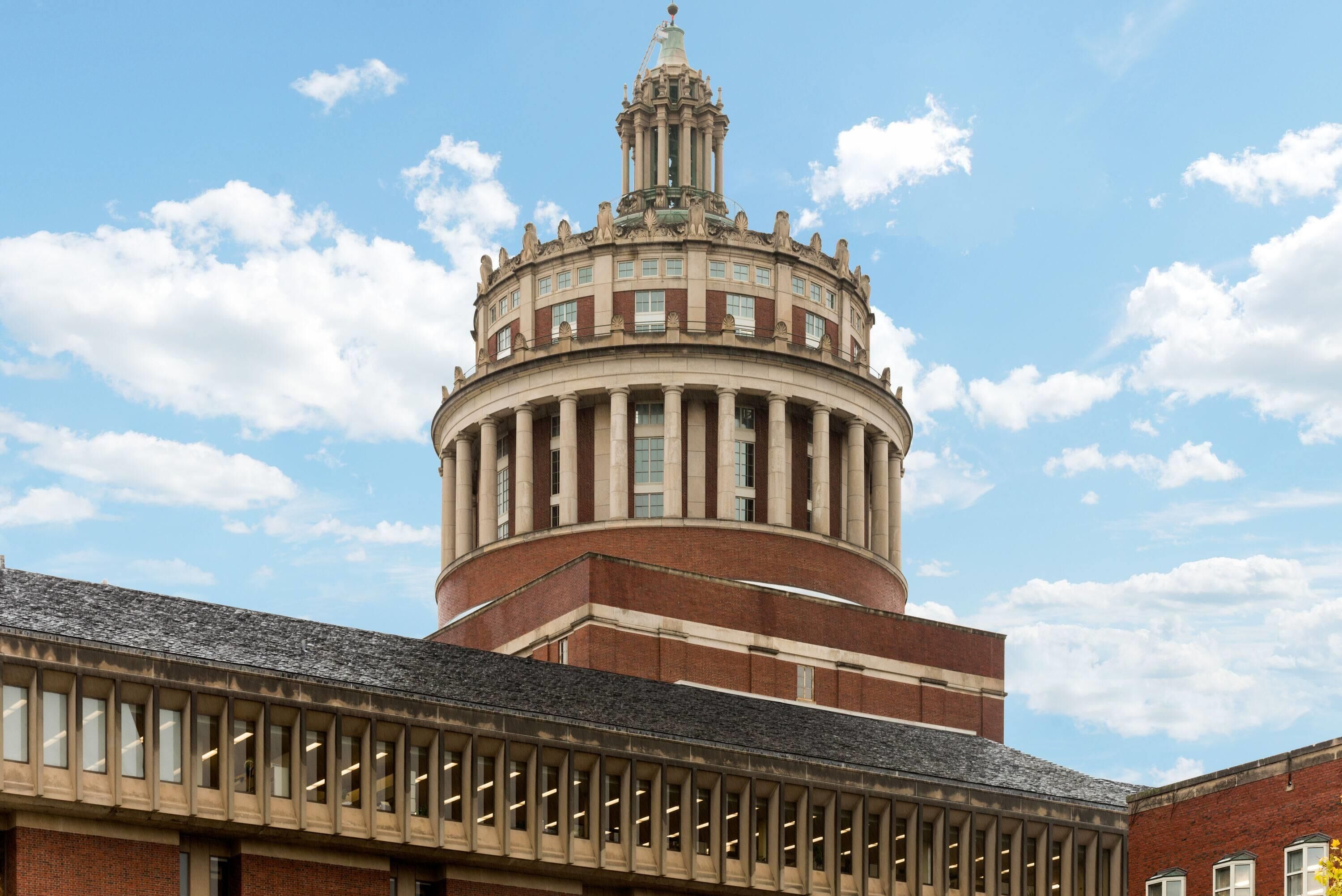 A historic building with a central dome and a tower.
