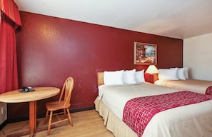 A hotel room with two beds, a wooden chair, a small table with a telephone, and a wall-mounted painting. - Red Roof Inn Lompoc (Lompoc)