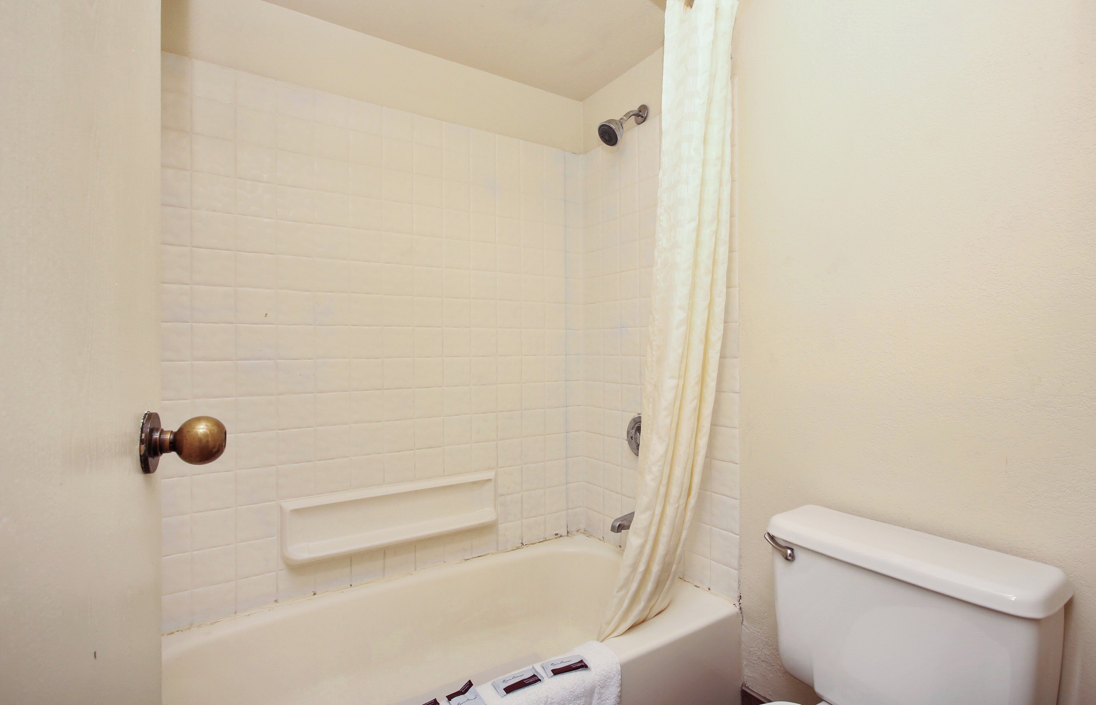 A bathroom with a bathtub, a shower, and a toilet.