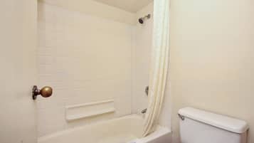 A bathroom with a bathtub, a shower, and a toilet.