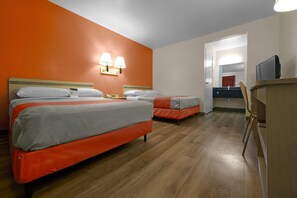 A hotel room with two beds, a desk, a chair, and a television. - Motel 6 Saint Joseph, MO (St. Joseph)
