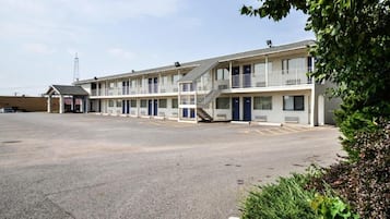 A motel with a central corridor and individual rooms on either side.