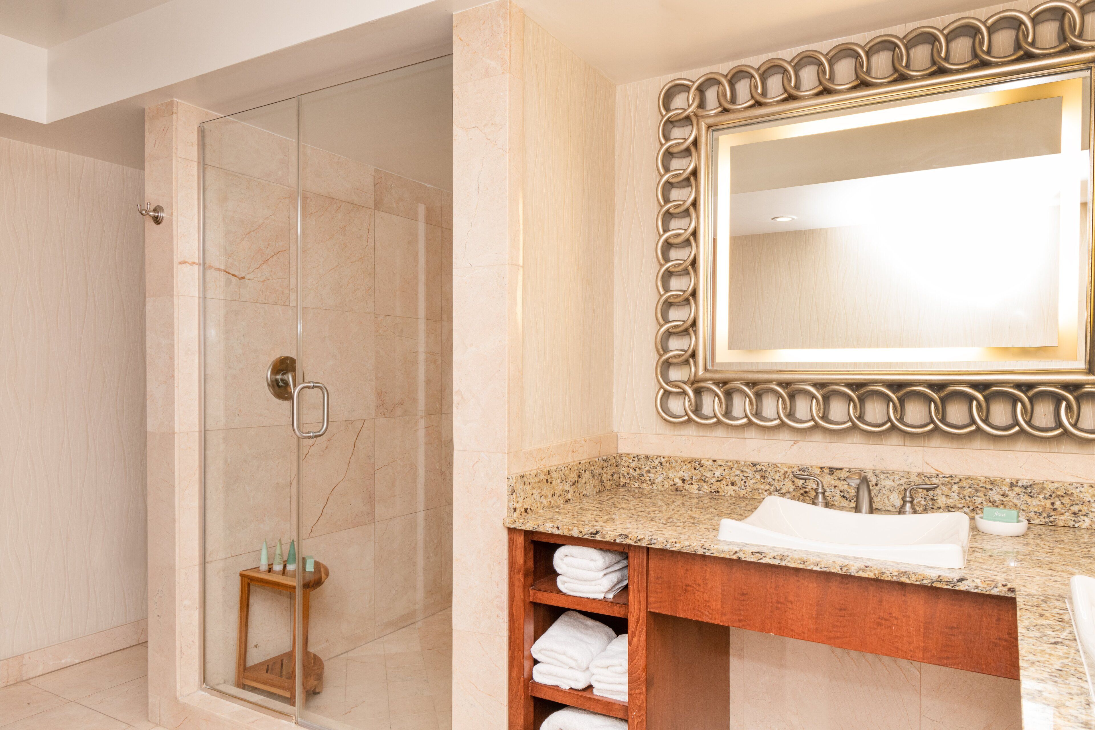 oceanfront presidential king balcony suite | bathroom | shower, designer toiletries, hair dryer, bathrobes