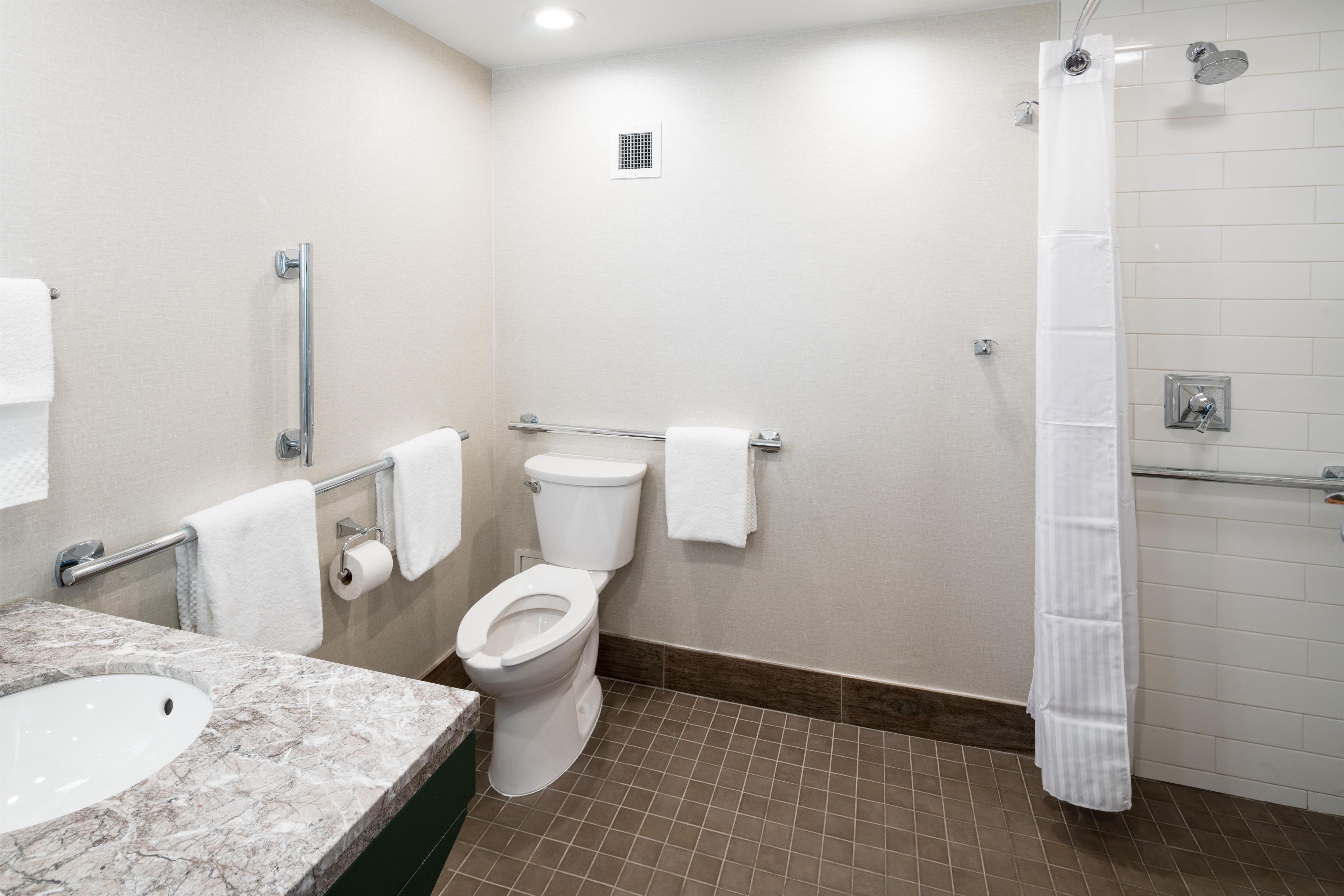 A bathroom with a toilet, a sink, and a shower.