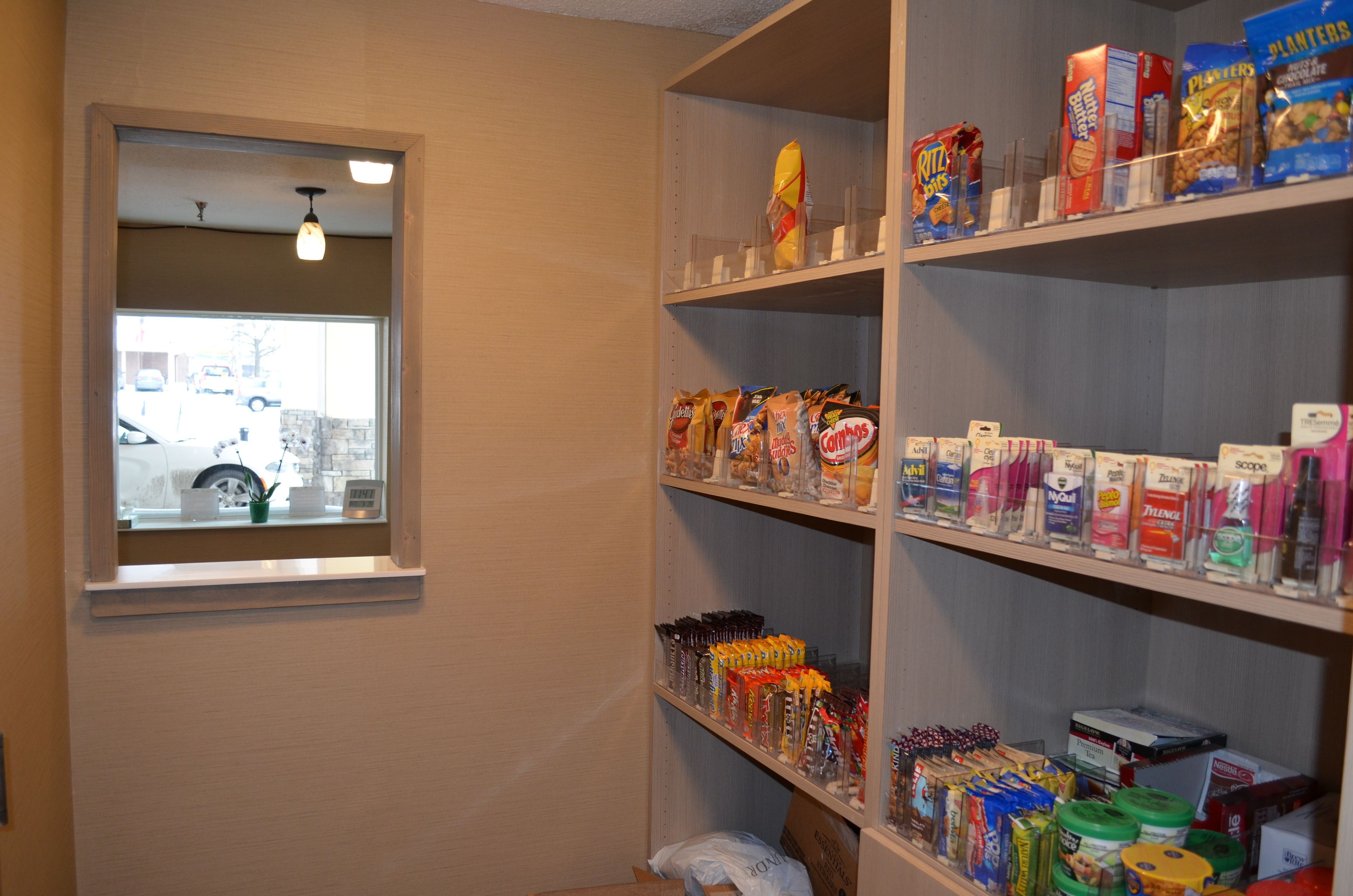 A storage area with shelves stocked with various food items and household goods.