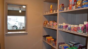 A storage area with shelves stocked with various food items and household goods.