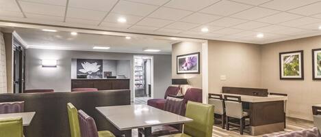 Enjoy casual dining in a bright and airy space with a central table and comfortable seating.