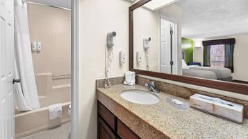 A bathroom with a sink, mirror, and hairdryer.