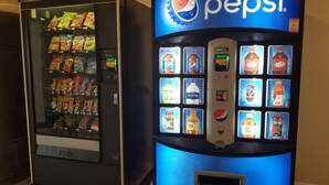A vending machine with Pepsi branding and a variety of snacks and drinks. - Studio 6 Sacramento, CA - Natomas & SMF Airport (Sacramento)