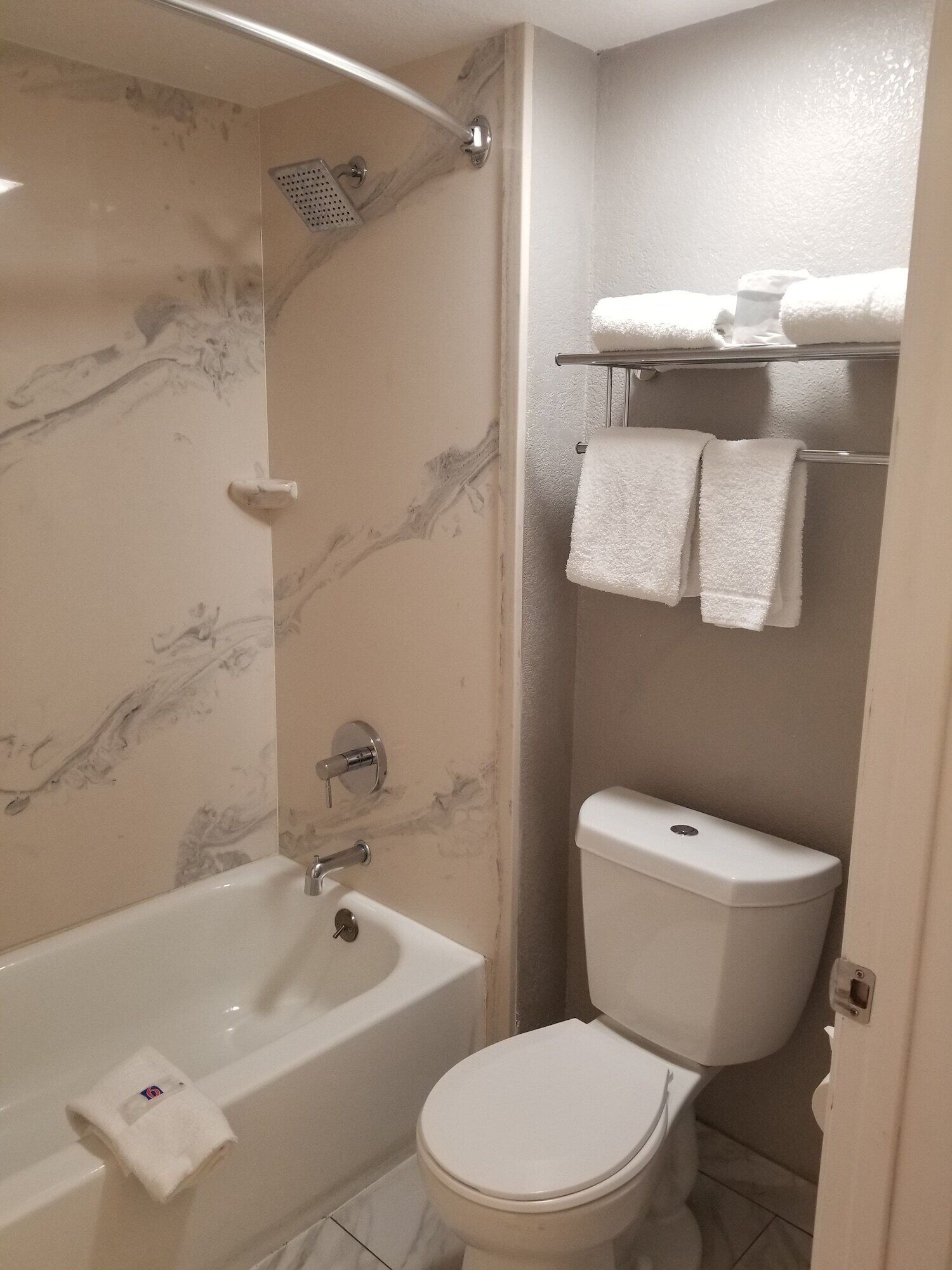 A bathroom with a bathtub, toilet, and a shower.