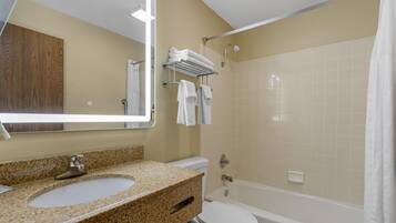 A bathroom with a sink, toilet, and bathtub.