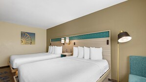 A hotel room with two beds, a nightstand, a lamp, and a wall-mounted clock.