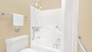 A bathroom with a bathtub, toilet, and towel rack. - Super 8 by Wyndham East Moline (East Moline)