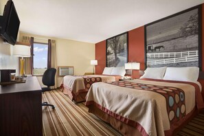 A hotel room with two beds, a desk, a chair, a TV, and a large painting on the wall. - Super 8 by Wyndham Mattoon (Mattoon)