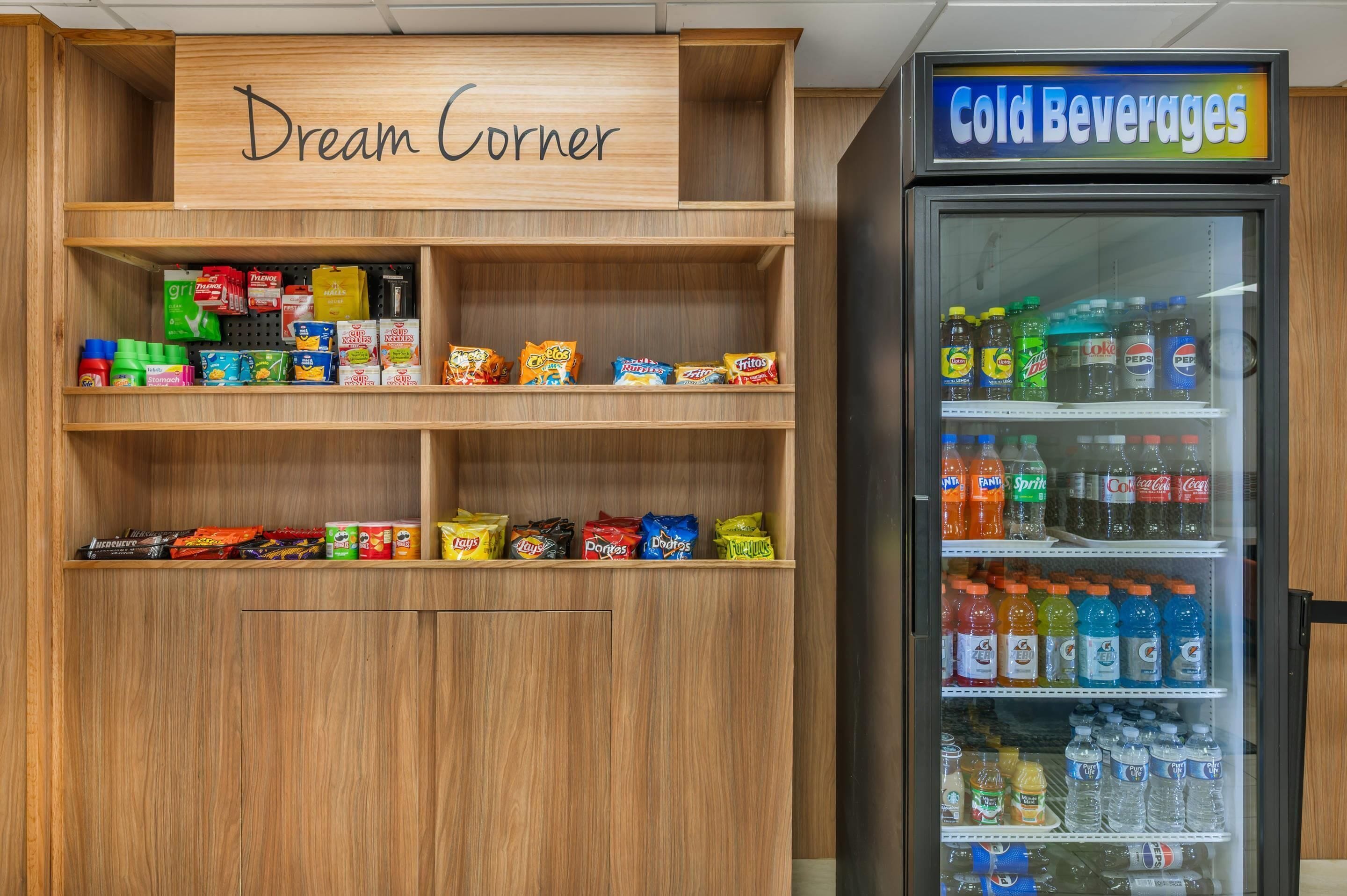 A snack and cold beverage display area with shelves stocked with various snacks and a refrigerated section with cold drinks.