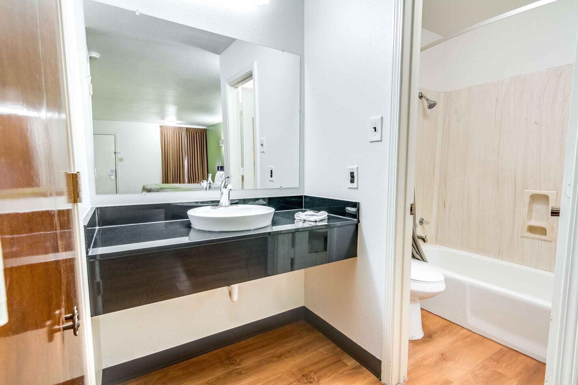 Bathtub, hair dryer, towels, toilet paper