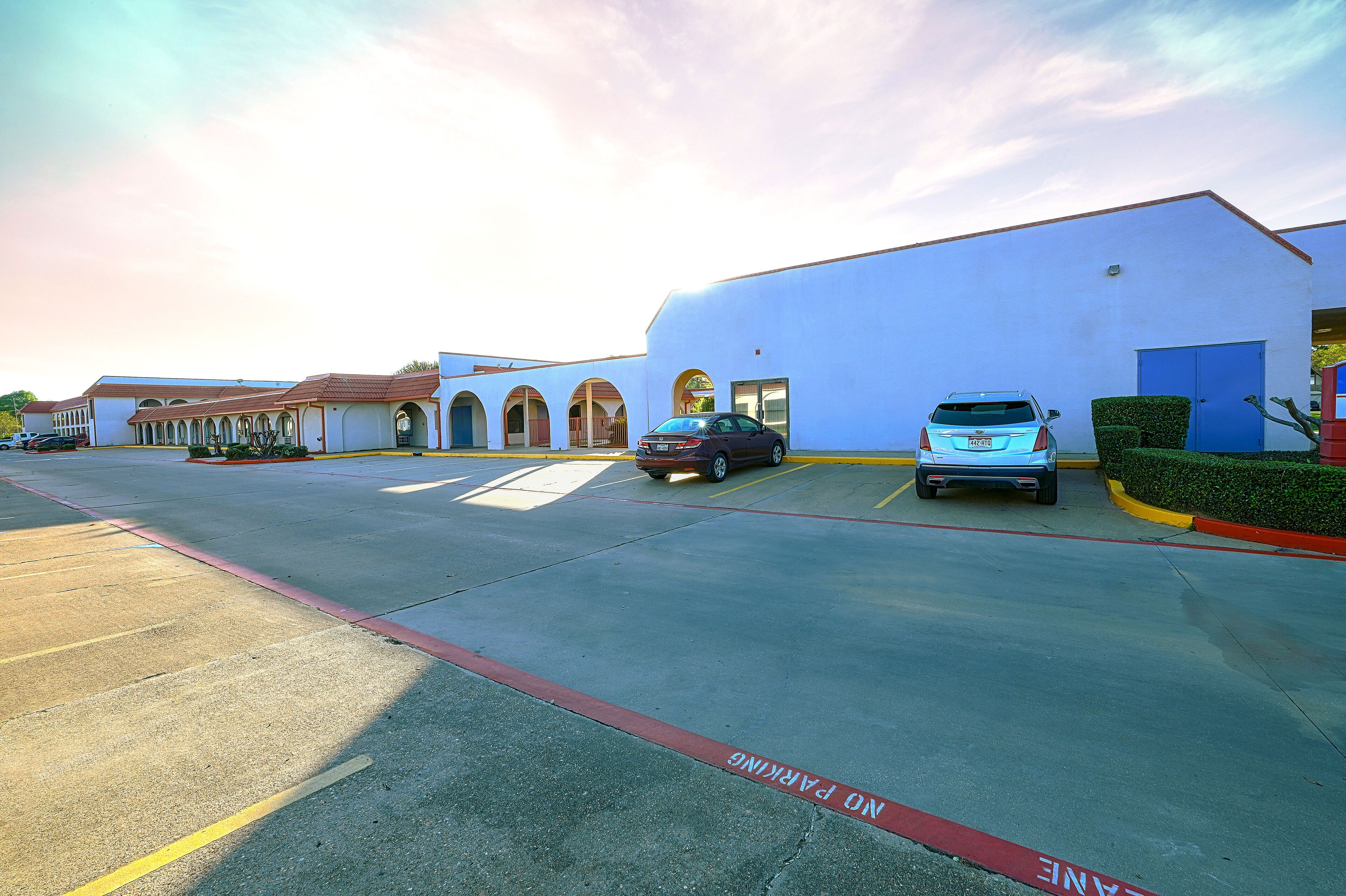 A parking lot with a building in the background.