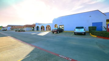 A parking lot with a building in the background.