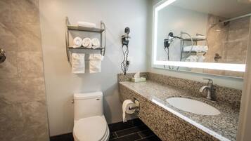 A bathroom with a toilet, sink, and towel rack.
