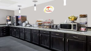 A commercial kitchen with a Superstart breakfast sign, a microwave, toaster, and various food items on the counter. - Super 8 by Wyndham Logansport (Logansport)
