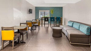 A modern dining area with a sofa, chairs, and a table.