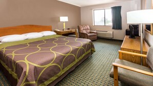 A hotel room with a large bed, a desk, a chair, a TV, and a window with curtains. - Super 8 by Wyndham St. Charles (St. Charles)