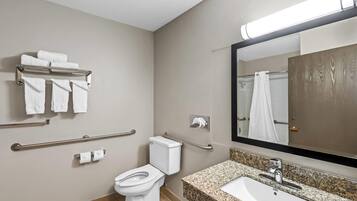A modern bathroom with a toilet, sink, and towel rack.