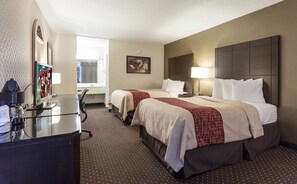 A hotel room with two beds, a desk with a computer, a TV, and a window. - Red Roof Inn & Suites DeKalb (DeKalb)