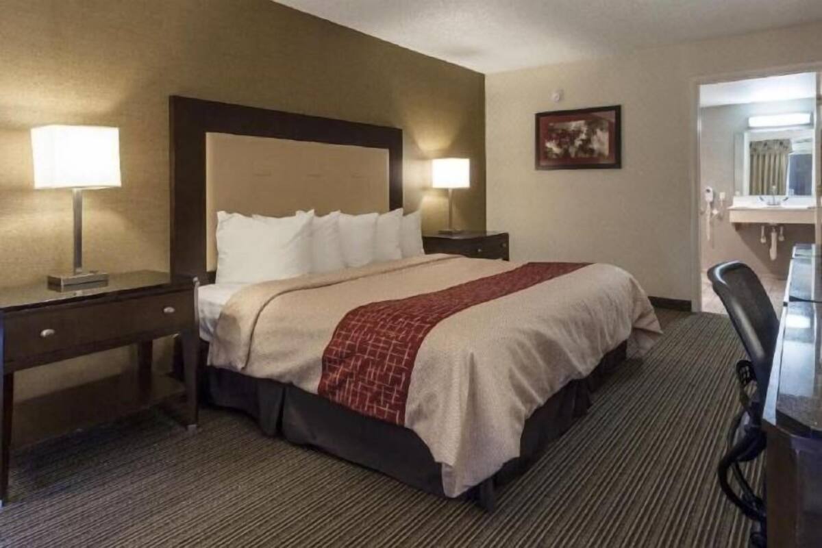 Desk, laptop workspace, blackout drapes, iron/ironing board