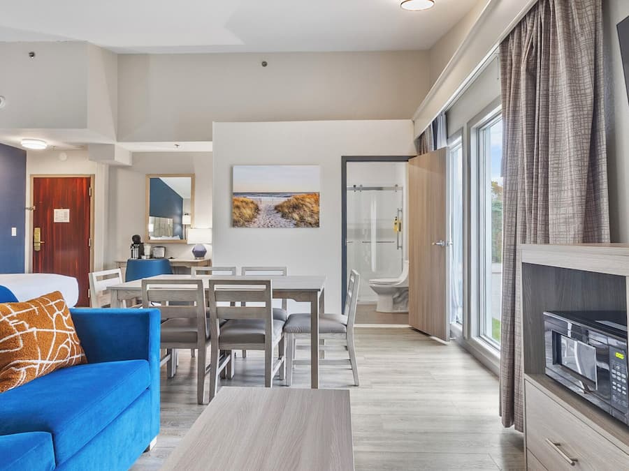 Suite, 2 Queen Beds, Non Smoking, Refrigerator & Microwave (Larger Room;with Sofabed) | Living area | 55-inch Smart TV with cable channels