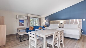 A hotel room with a bed, a desk, a chair, a sofa, and a window with curtains. - Best Western Plus The Inn at Hampton (Hampton)