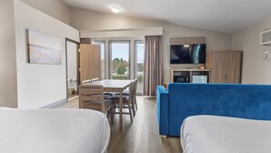 A hotel room with two beds, a dining table, a TV, and a kitchenette. - Best Western Plus The Inn at Hampton (Hampton)