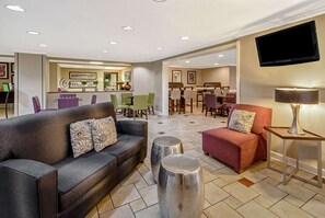 Relax in the stylish lobby with a seating area, flat-screen TV, and dining space.