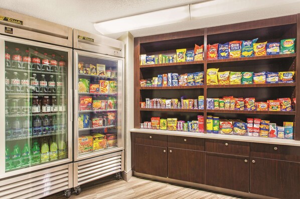 A snack and beverage vending area with refrigerated and shelf-stocked options.