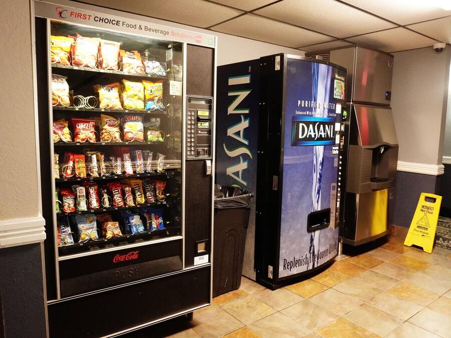 A vending machine with a variety of snacks and a water dispenser.