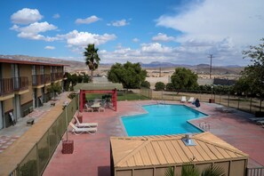 Outdoor pool, open 7:00 AM to 10:00 PM, pool loungers