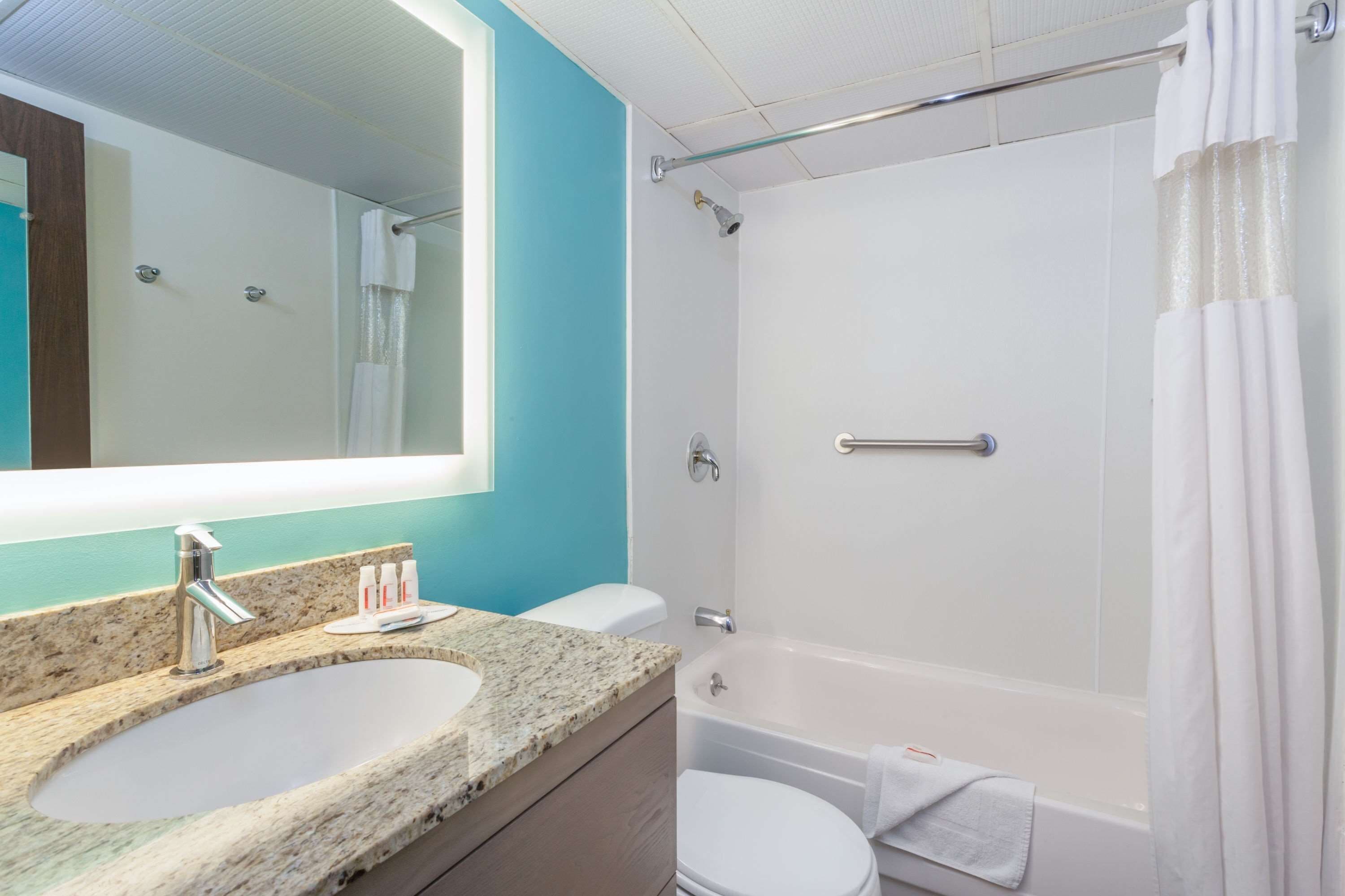 A bathroom with a sink, toilet, and bathtub.