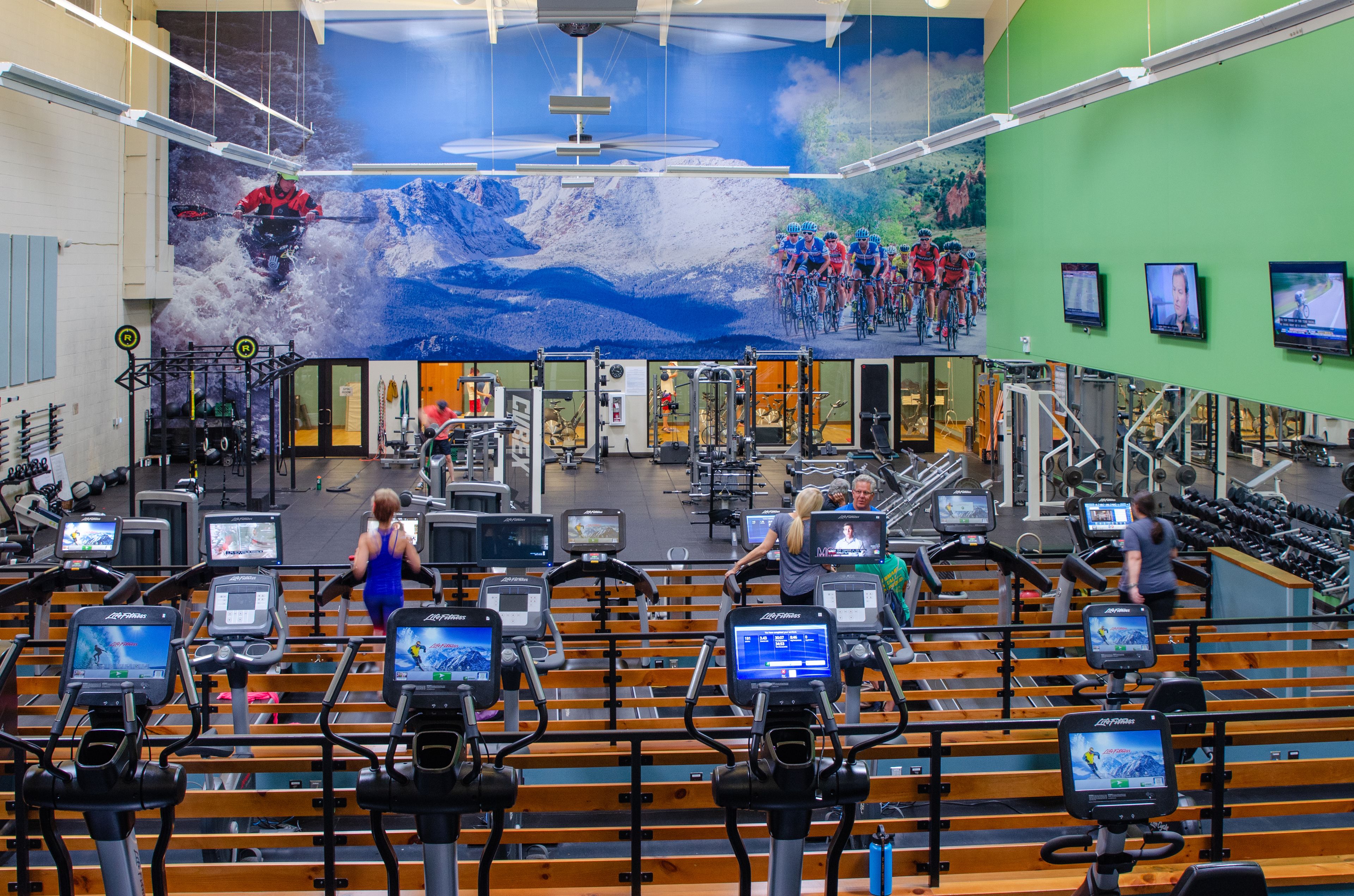 A gym with stationary bikes, treadmills, and weight machines.