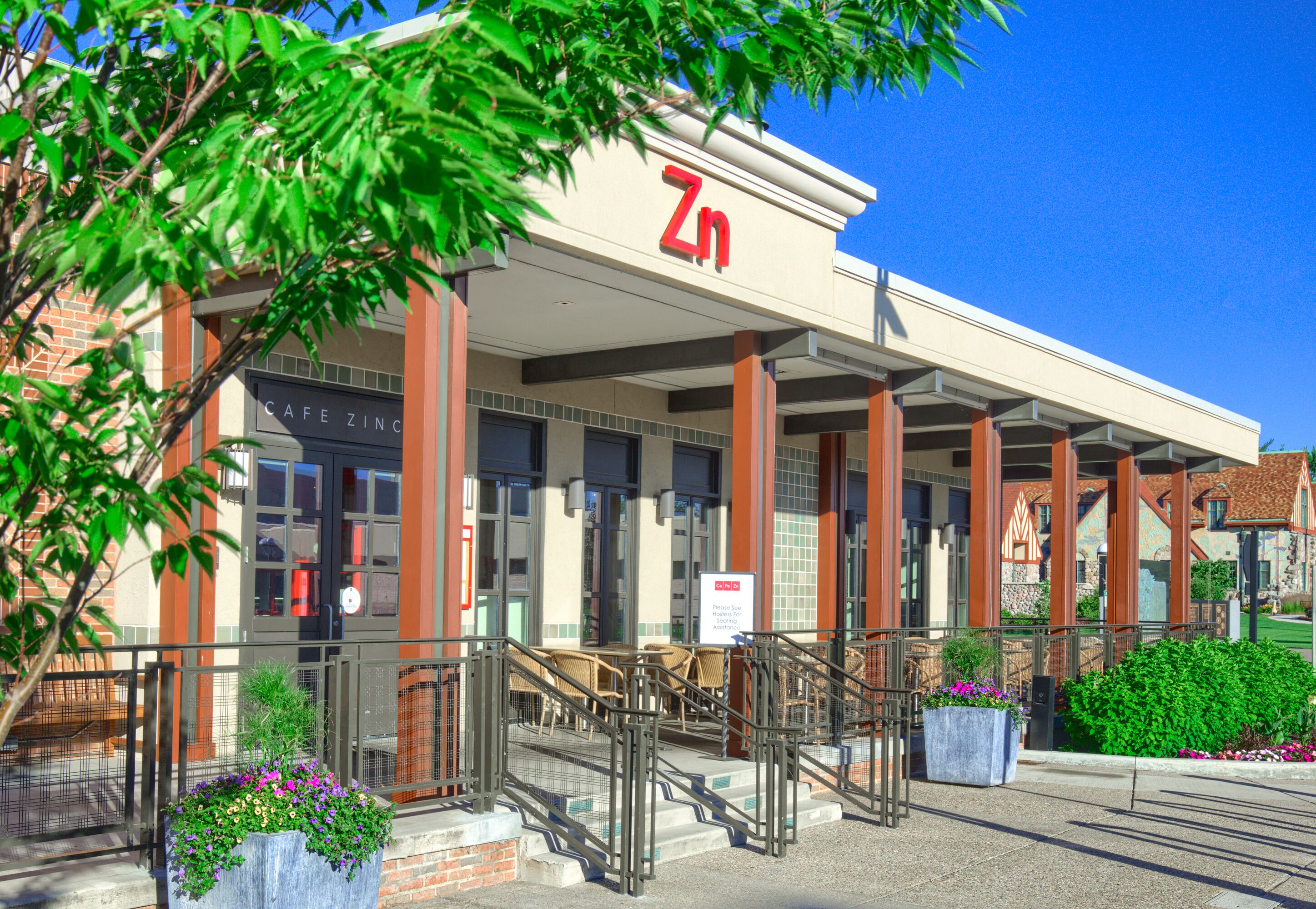 A building with a sign reading "Zinc" and a cafe named "Cafe Zinc" inside.