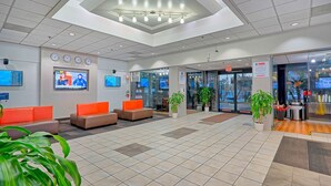 A lobby with seating areas, a reception desk, and a coffee station. - Motel 6 Los Angeles, CA - Los Angeles - LAX (Inglewood)