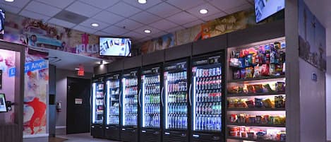 A vending area with multiple beverage dispensers and snack shelves.