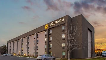 A modern hotel building with a prominent sign reading "LA QUINTA".