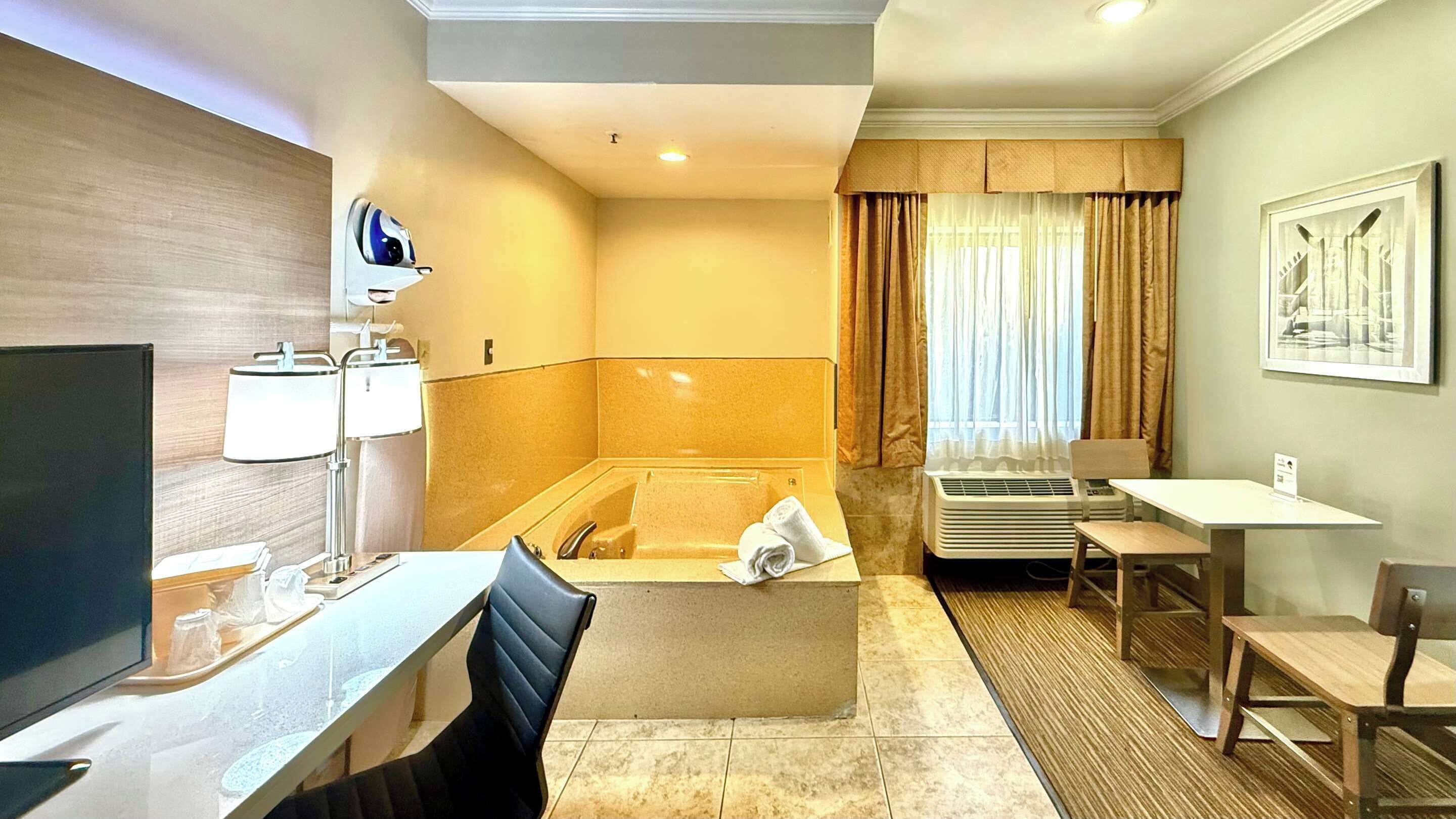 Deluxe Room, 1 King Bed, In-Room Jetted Tub, Non Smoking | In-room safe, desk, laptop workspace, blackout curtains